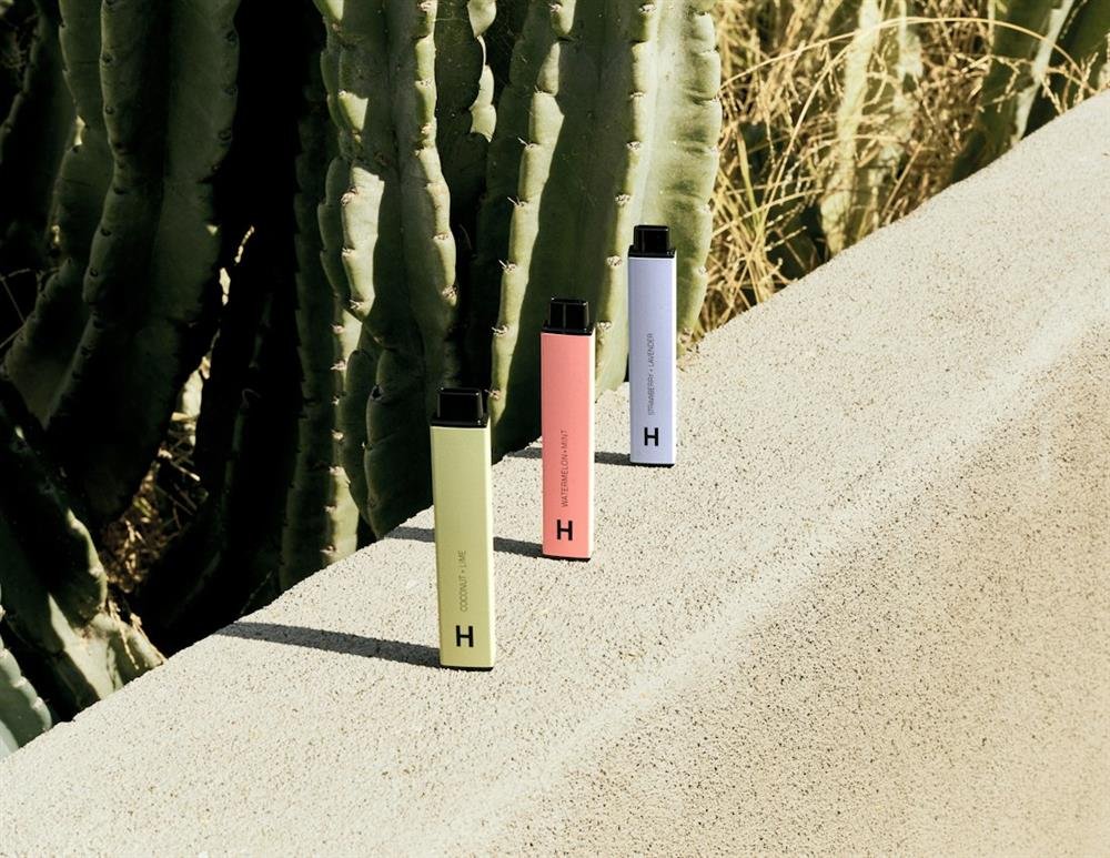 Three disposable vape devices in pastel colors